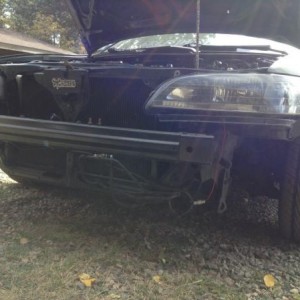 Front end before parts car had bent bumper retainers and a rusty old horn. old headlights from florida