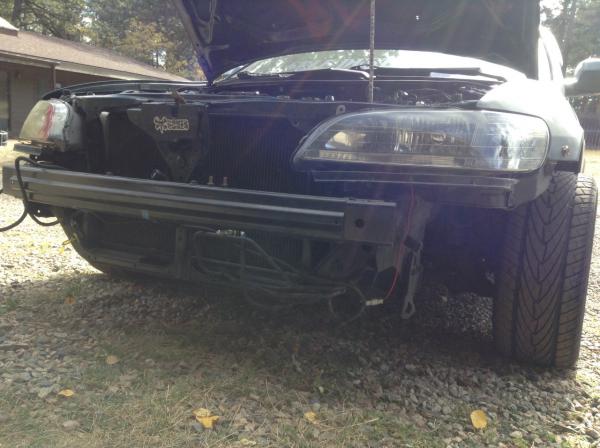 Front end before parts car had bent bumper retainers and a rusty old horn. old headlights from florida